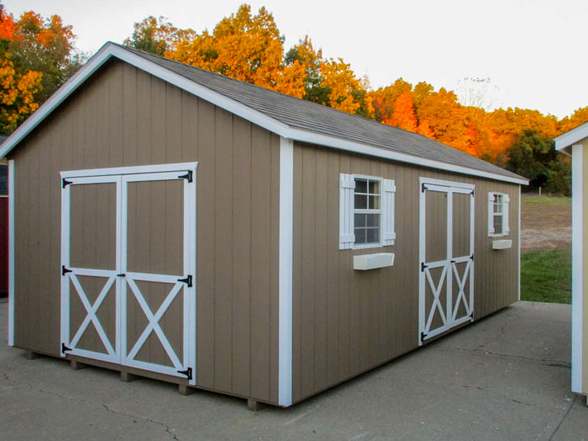 Gray A-frame storage shed with double doors and windows