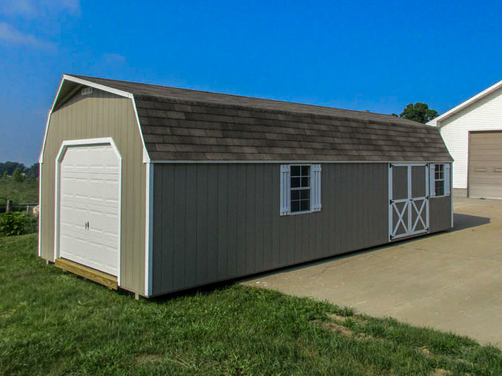 Gambrel garage with broad overhead door