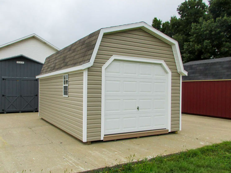 Gambrel garage with overhead garage door and side entry